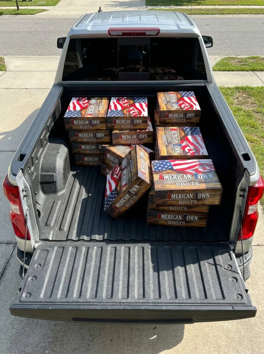 Cases of boots loaded in a pickup truck bed