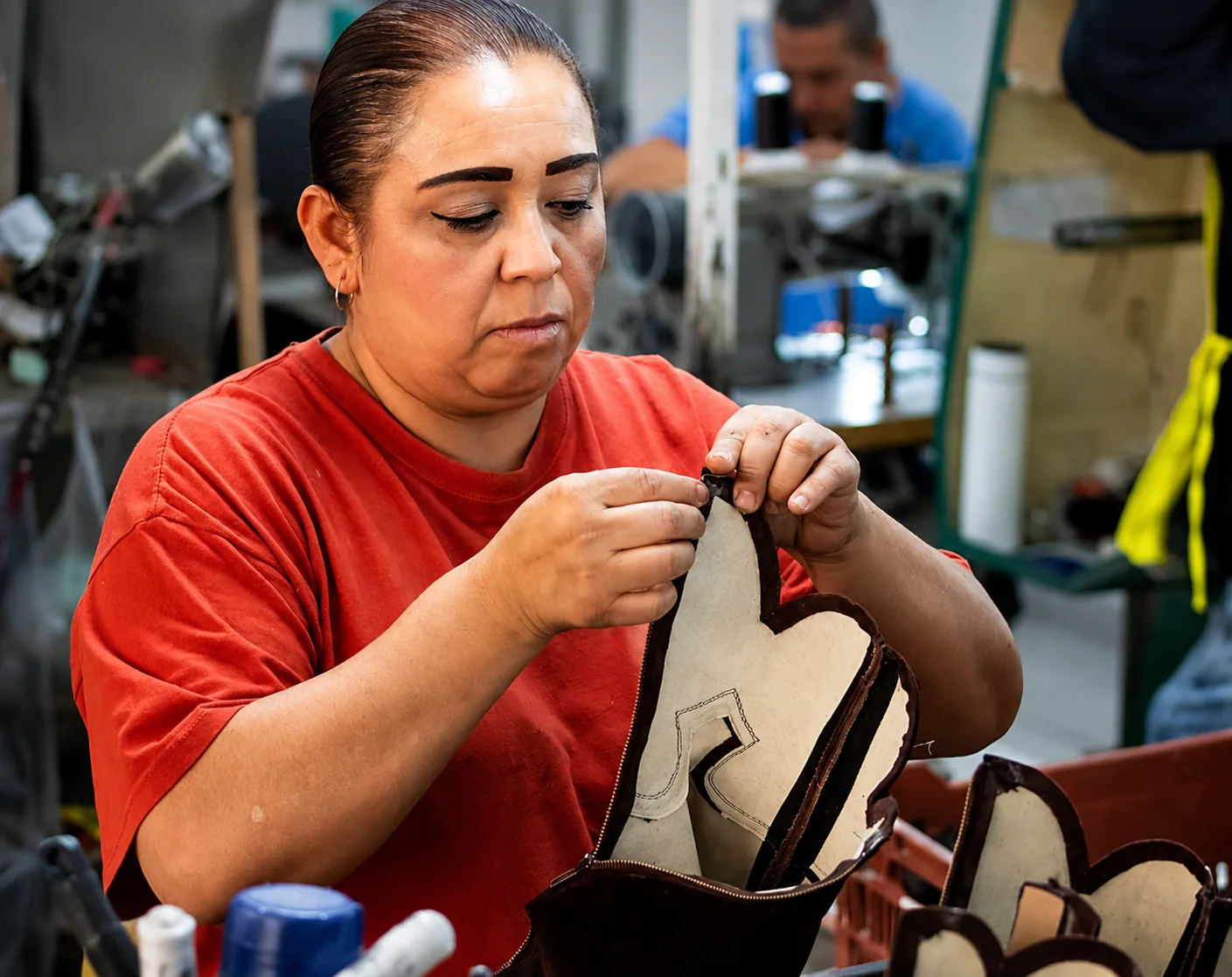 Hands stitching a boot